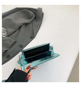 Detailed view of lake green embossed leather handbag interior with magnetic silver clasp