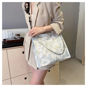 Detail der floralen Schmetterling-Jacquard-Tasche mit elegantem Holzperlen-Anhänger