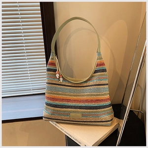 Detailed macro of a colorful woven tote bag with striped pattern and beaded zipper detail