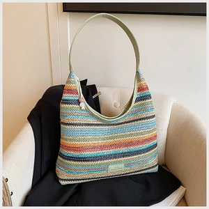 Close-up of colorful woven fiber texture and green leather strap on the tote bag