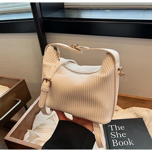 Détail du sac à main blanc en velours côtelé avec boucles dorées et bandoulière