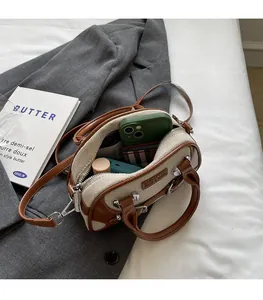 Internal view of a canvas Boston bag showing capacity with phone and lipstick