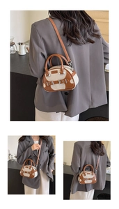 Detail of retro Boston bag showing leather canvas stitching and metal buckle design