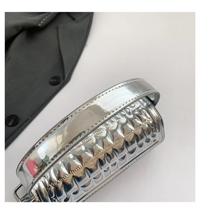 Close-up of a silver metallic tote bag with quilted puffy texture and glossy finish