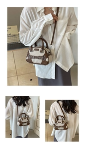 Close-up of a retro canvas and brown leather bowling bag with contrast stitching