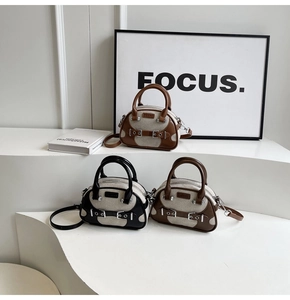 Detailed view of vintage patchwork canvas handbags in black and brown on white stairs