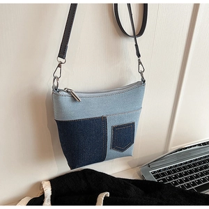 Detailansicht der Denim Patchwork Tasche mit gelben Nähten und silbernem Metallreißverschluss