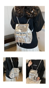 Silver metallic backpack with quilted chain straps shown in various carrying styles