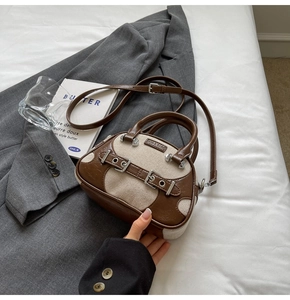 Close-up of vintage Boston bag featuring brown leather and beige canvas contrast texture