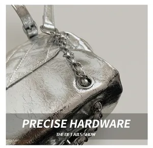 Detail of silver quilted leather texture with classic metal chain strap and stitching