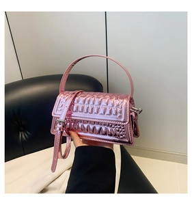 Detail of a purple metallic handbag with a textured surface and elegant top handle