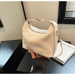 Détail du sac hobo en velours côtelé crème avec zip doré et texture côtelée