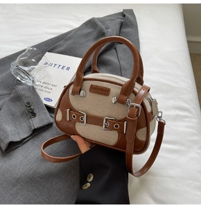 Detail of vintage contrast tote bag featuring brown leather and beige canvas texture