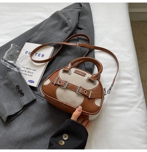 Detail of vintage contrast color handbag with brown leather and beige canvas textures
