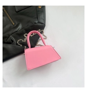 Pink mini leather handbag with silver chain strap shown from a stylish top-down view