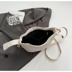 Vue intérieure du sac plissé montrant la doublure noire et la poche zippée interne