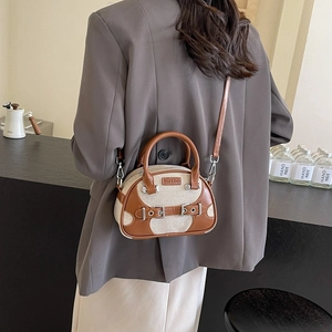 Retro contrast color pillow bag in brown leather and canvas shown on a model