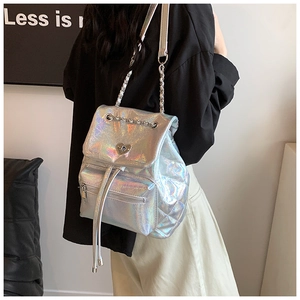 Close-up of holographic backpack featuring a heart-shaped buckle and chain straps