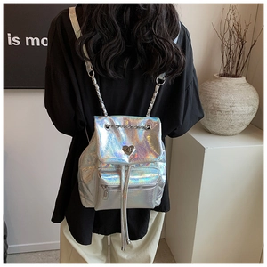 Detail of silver holographic backpack with heart-shaped metal twist lock and chain straps