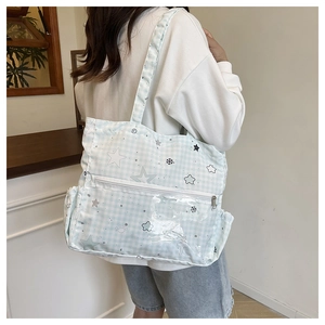 Detail of cute canvas tote bag with star patterns and clear front PVC pocket for students