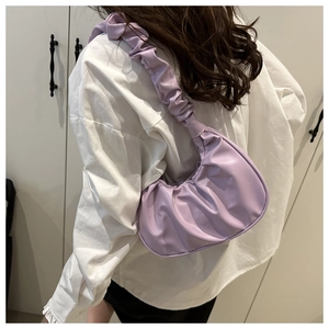 Detail view of lavender ruched hobo bag with pleated texture on shoulder strap