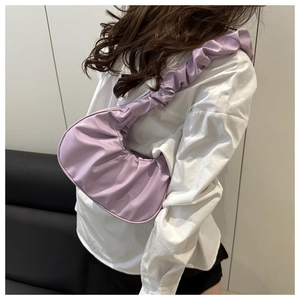 Close-up of light purple pleated cloud bag showing soft faux leather texture and detail