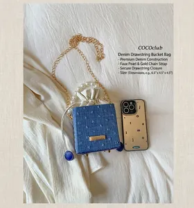 Blue tweed mini drawstring bucket bag size comparison with pearl handle and chain