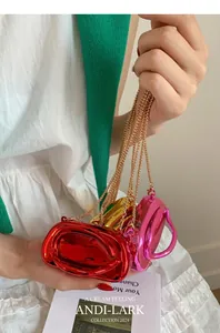 Mini acrylic party bags in red, gold, and pink with round handles and metal chains