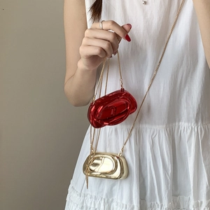 Detail of the iconic 3D metal buckle and chain on this stylish metallic crossbody bag