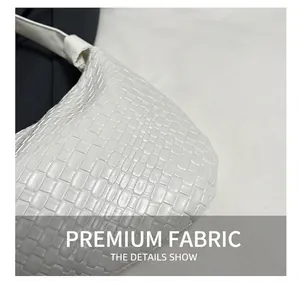 Detail shot of the white woven texture and premium PU leather finish on this large tote bag