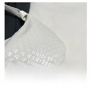 Detail shot of the white woven texture and premium PU leather finish on this large tote bag
