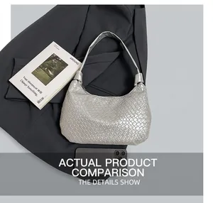 Detail of silver woven hobo bag showing metallic texture and size comparison with phone
