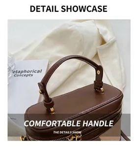 Dettaglio del manico in pelle vintage e cerniera in metallo dorato sulla borsa box