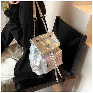 Close-up of holographic silver quilted backpack with heart buckle and chain strap