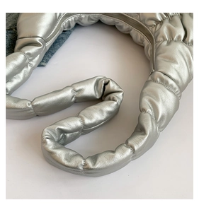 Close-up of metallic silver pleated cloud bag with quilted texture and zipper