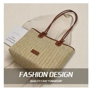 Detailed close-up of beige woven straw tote bag with brown faux leather trim and handles
