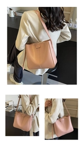 Dettaglio della borsa a secchiello in pelle rosa con cuciture fini e zip scorrevole