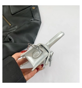 Close-up of a silver mini bag with metallic PU leather finish and bow detail