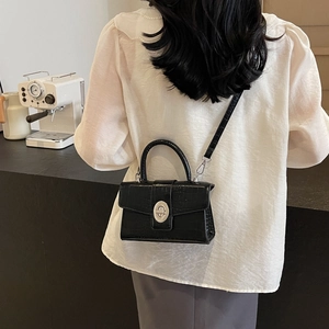 Chic black crocodile embossed square handbag with silver twist lock and leather strap