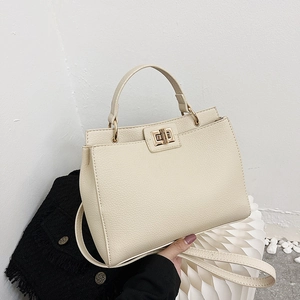 Chic cream-colored leather tote bag with a golden turn-lock and versatile shoulder strap