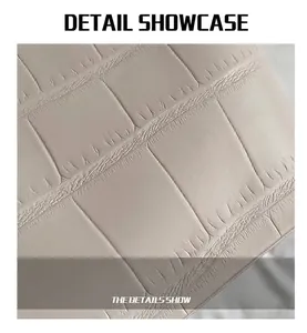Close-up of off-white faux crocodile leather texture and premium craftsmanship detail