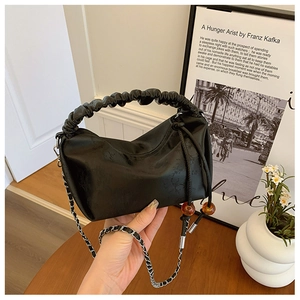 Détail du sac à main noir plissé avec perles orange et bandoulière en chaîne argentée