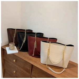 Group of crocodile pattern tote bags in four colors with gold chain shoulder straps