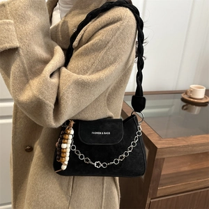 Elegant black suede crescent bag with woven strap and floral chain charm for women