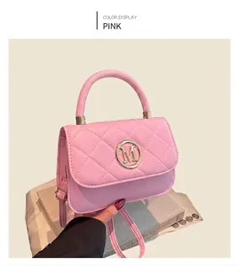 Detailed close-up of pink quilted crossbody bag with gold M logo in a black gift box