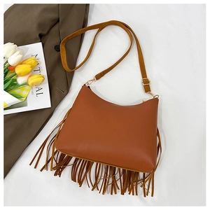 Top-down view of caramel fringe tote bag with gold hardware and stylish leather details