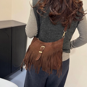 Brown suede crossbody tote with boho tassels shown on a model for casual daily style
