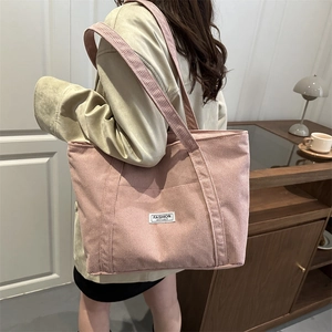 Pink corduroy tote bag for women shown as a stylish large capacity shoulder handbag