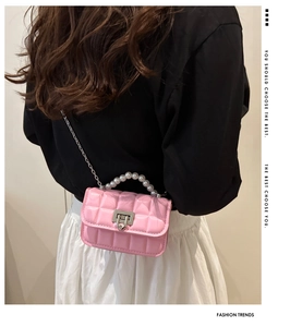 Pink quilted shoulder bag featuring elegant pearl handle and silver chain strap detail