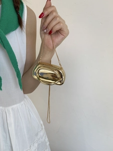 Elegant gold metallic hard-shell clutch bag with geometric liquid metal texture and chain